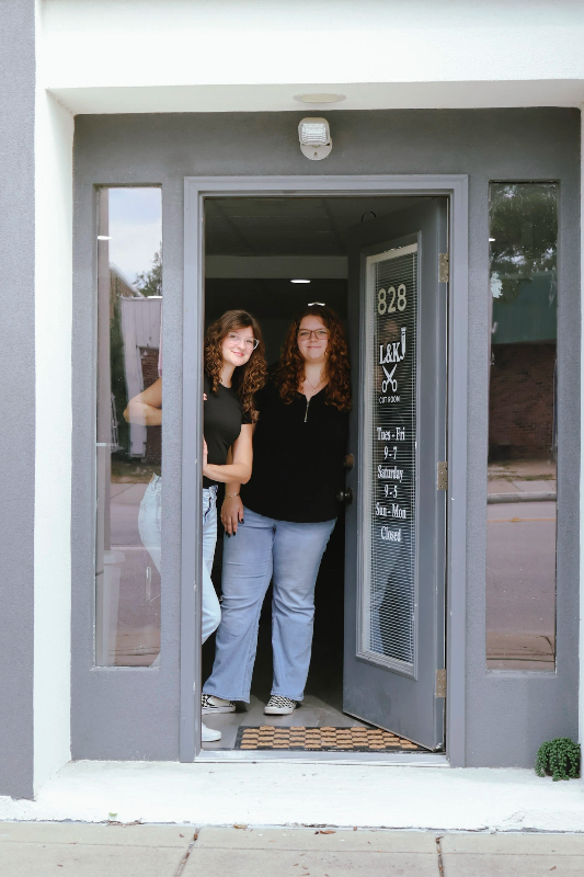 Lauren and KayLynn at the shop entrance